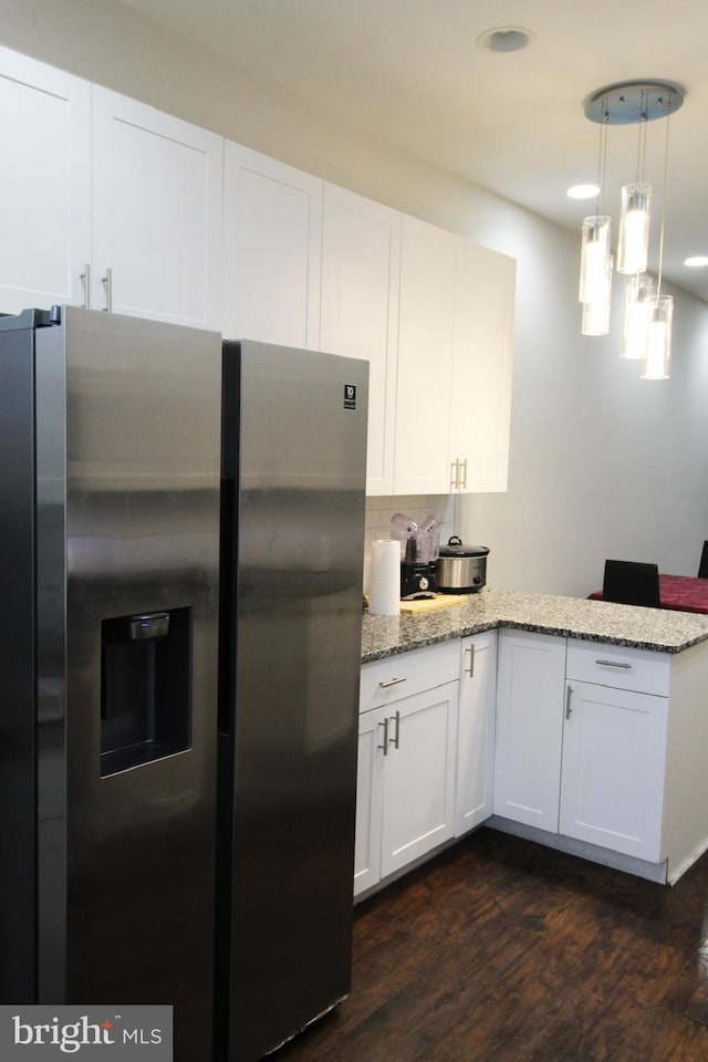 kitchen with white cabinetry, hanging light fixtures, dark hardwood / wood-style flooring, and stainless steel refrigerator with ice dispenser