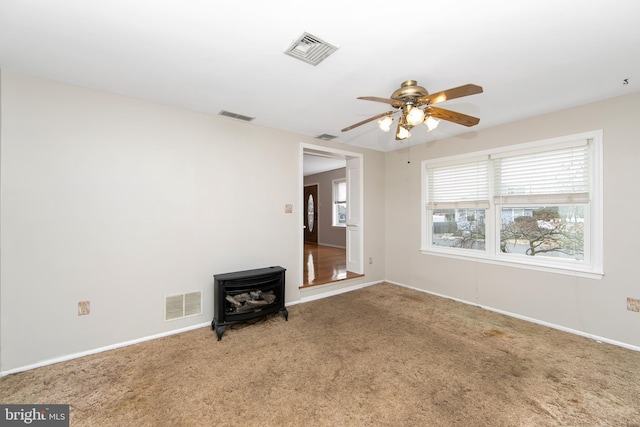 spare room featuring carpet and visible vents