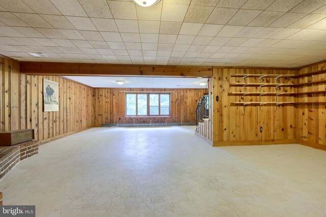 basement featuring wooden walls