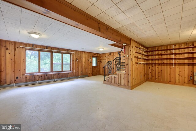 basement with wooden walls and a brick fireplace