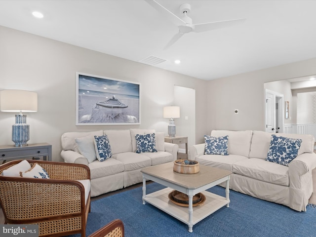 carpeted living room with ceiling fan