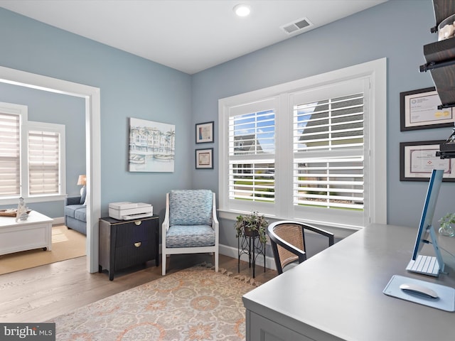 office area with light hardwood / wood-style floors