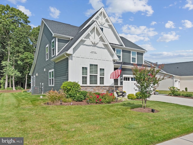 view of front of property featuring a front lawn, central air condition unit, and a garage