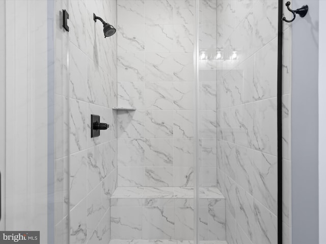 bathroom with a shower with door