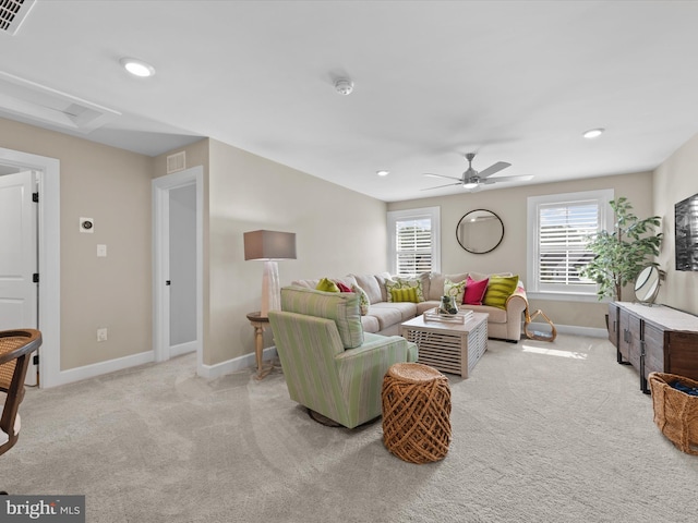 carpeted living room with ceiling fan