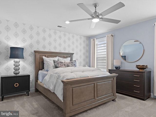 bedroom featuring ceiling fan and light colored carpet