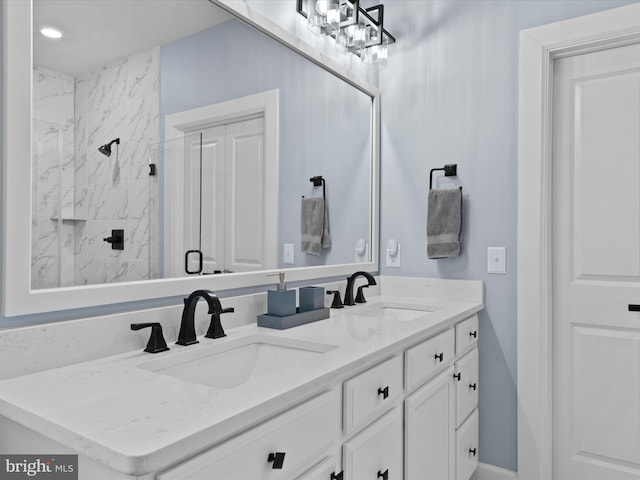 bathroom featuring vanity and a shower with door