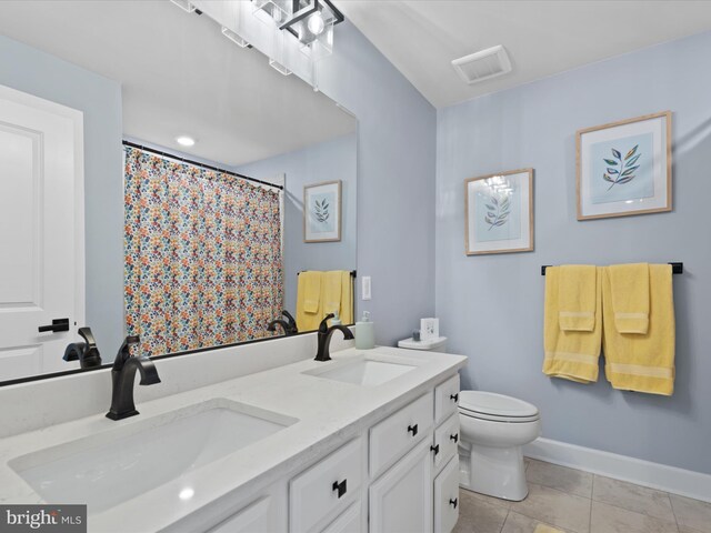 bathroom with walk in shower, vanity, toilet, and tile patterned floors