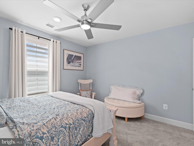 bedroom with ceiling fan and light carpet