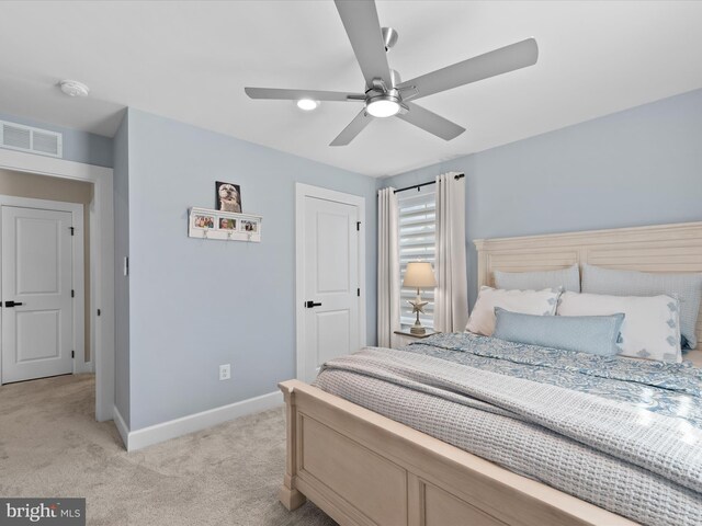 bedroom with ceiling fan and light colored carpet