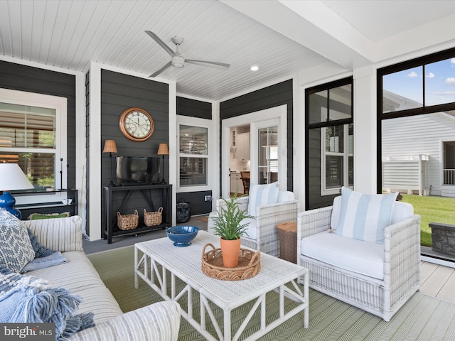 exterior space featuring a wealth of natural light, ceiling fan, and a fireplace