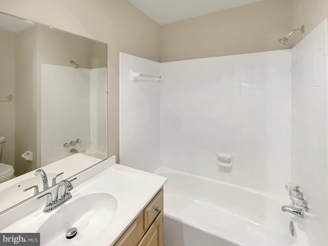 bathroom with bathing tub / shower combination, vanity, and toilet