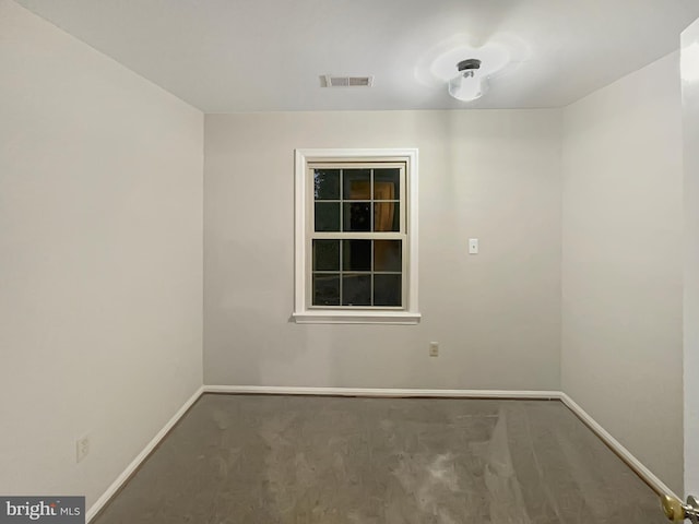 unfurnished room with visible vents and baseboards