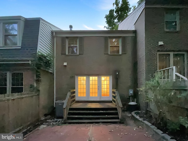rear view of property with french doors