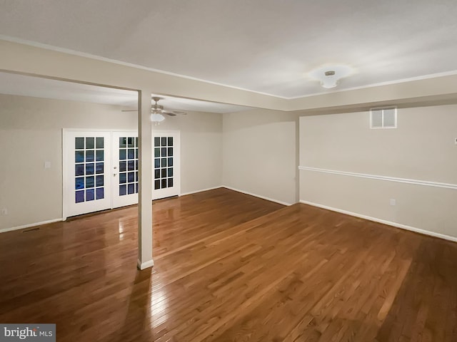below grade area featuring ceiling fan, visible vents, wood finished floors, french doors, and baseboards