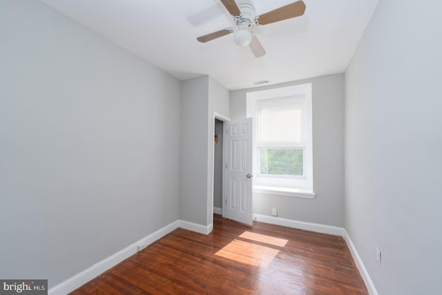 empty room featuring ceiling fan and dark wood-type flooring