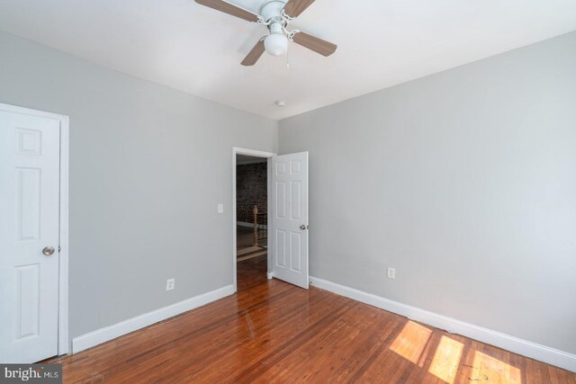 empty room with wood-type flooring and ceiling fan