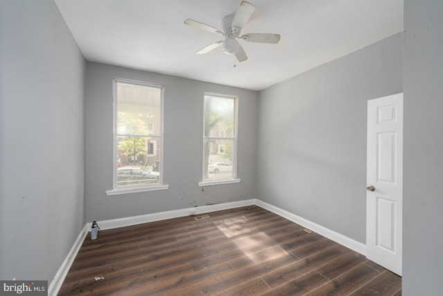 unfurnished room featuring ceiling fan and dark hardwood / wood-style flooring