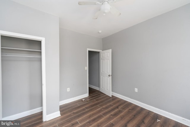 unfurnished bedroom with a closet, ceiling fan, and dark hardwood / wood-style flooring