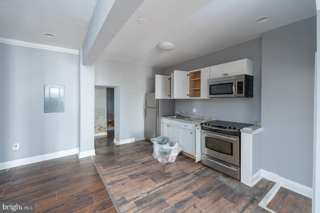 kitchen featuring light stone counters, white cabinets, dark hardwood / wood-style flooring, stainless steel appliances, and crown molding