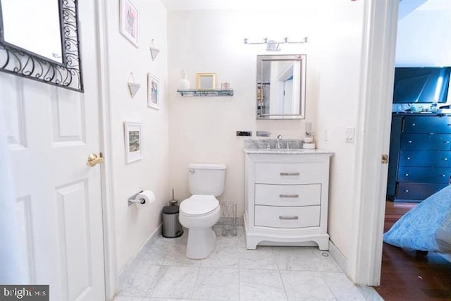 bathroom featuring vanity and toilet