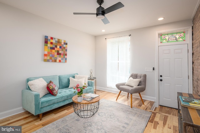 living room with ceiling fan and hardwood / wood-style floors