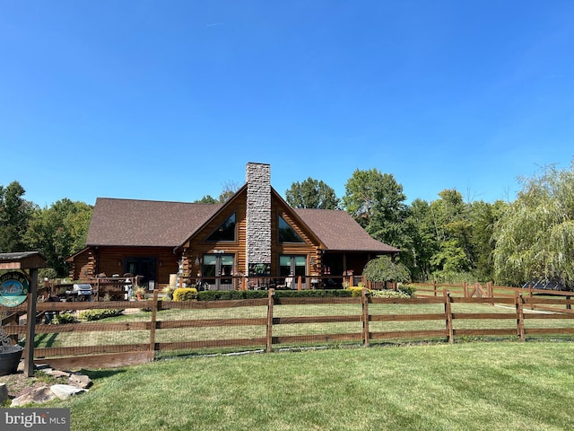 rear view of property with a yard