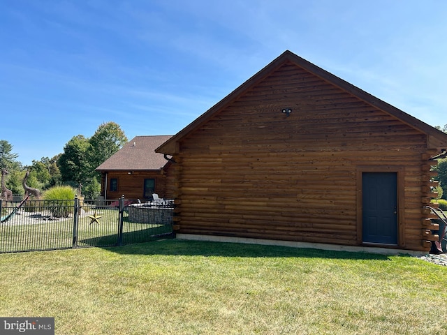 view of side of home with a lawn