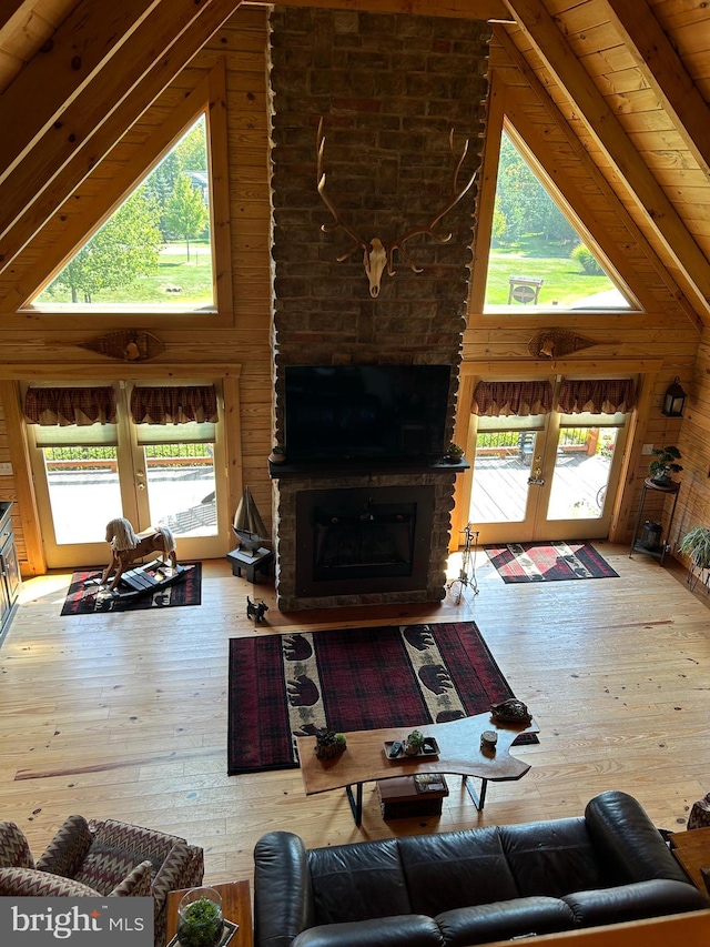 living room featuring a wealth of natural light, hardwood / wood-style flooring, and french doors