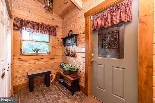 interior space with wooden ceiling, wood walls, and lofted ceiling with beams