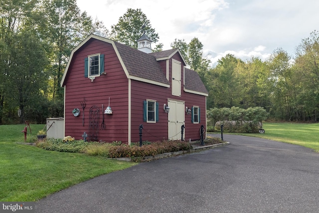 view of property exterior with a lawn