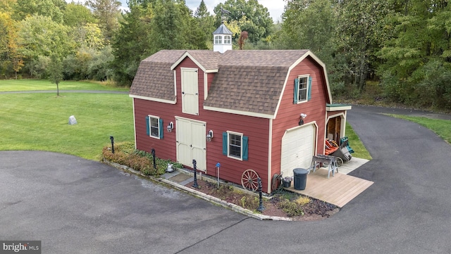 view of front of property with a front yard and a garage