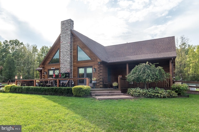 rear view of property with a yard and a deck