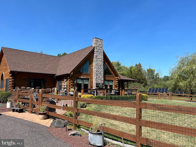 log cabin featuring a front lawn