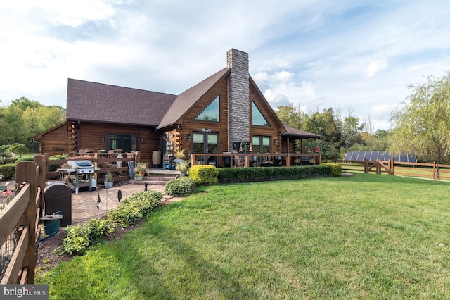 rear view of property with a patio and a yard