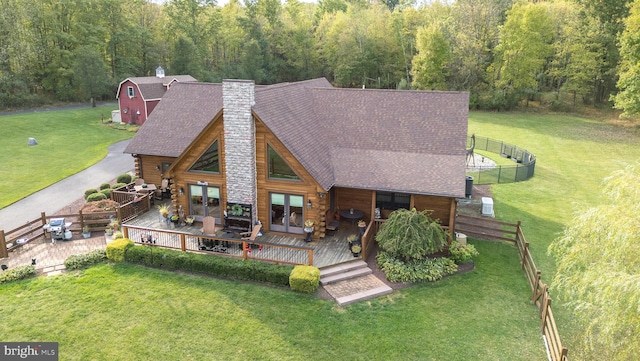 rear view of house with a lawn and a deck