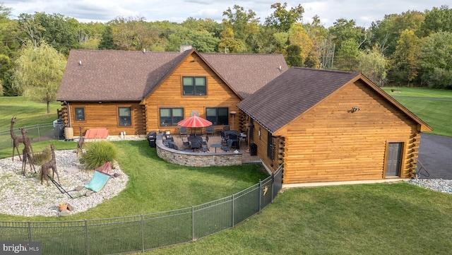 view of front of house featuring a front lawn and a patio area