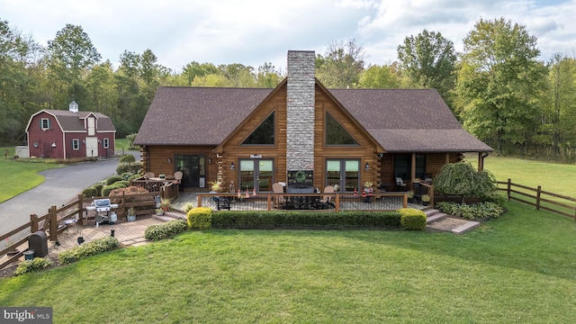 back of property featuring a yard and a wooden deck