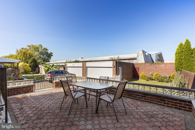 view of patio / terrace with an outdoor structure and a garage