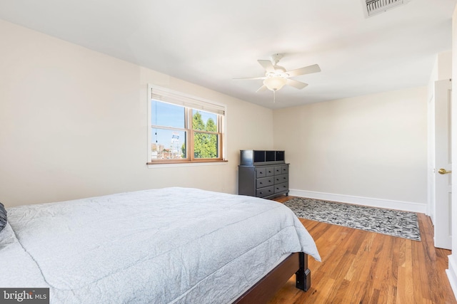 bedroom with hardwood / wood-style floors and ceiling fan