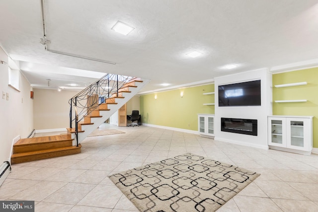 unfurnished living room with a baseboard heating unit, light tile patterned floors, rail lighting, and a textured ceiling