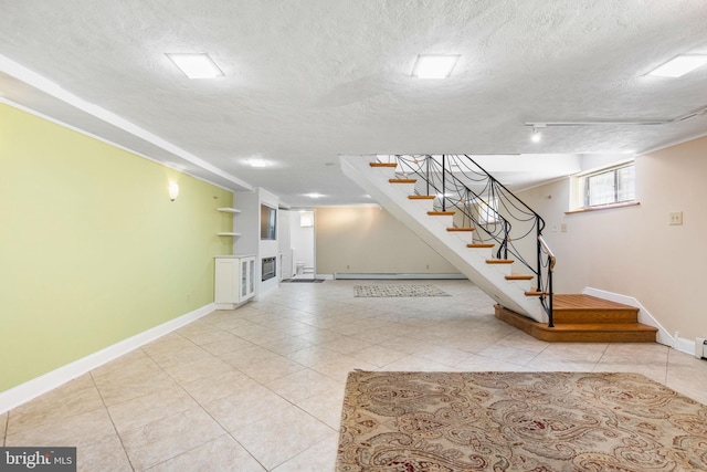 basement featuring a textured ceiling, baseboard heating, and light tile patterned floors