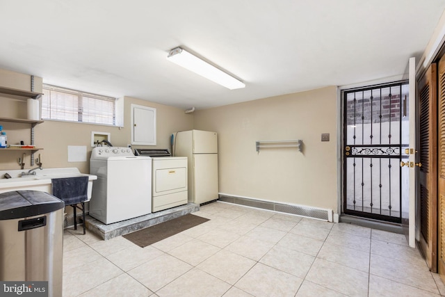 clothes washing area featuring light tile patterned floors and washing machine and clothes dryer