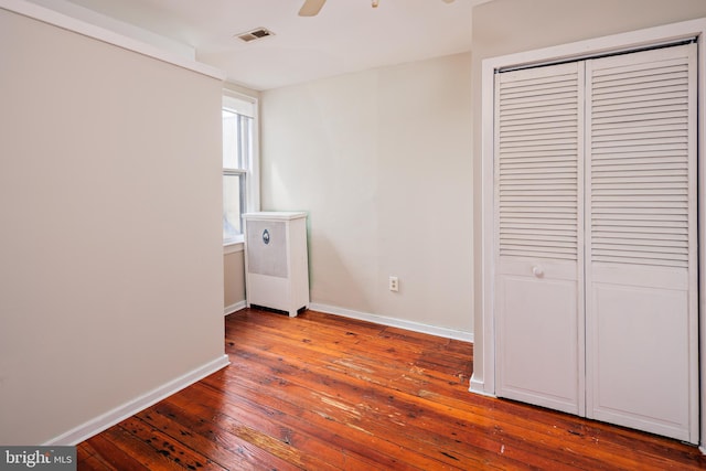 laundry room with ceiling fan and wood-type flooring