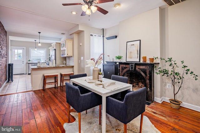 dining room with ceiling fan and light hardwood / wood-style flooring