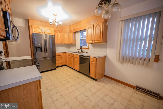 kitchen with hanging light fixtures, stainless steel appliances, an inviting chandelier, and sink