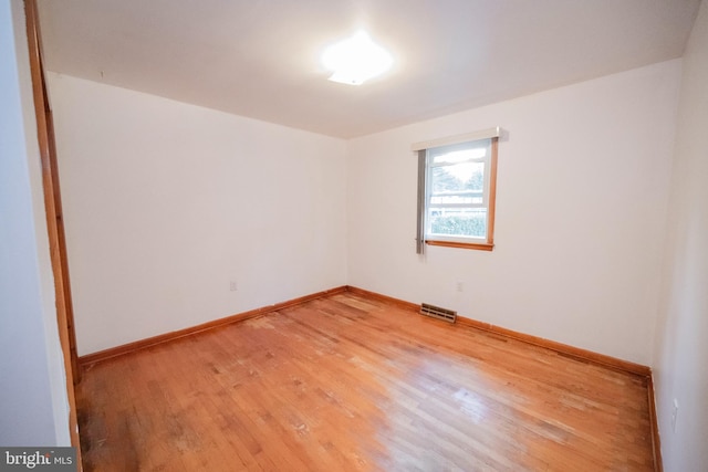 empty room with hardwood / wood-style floors