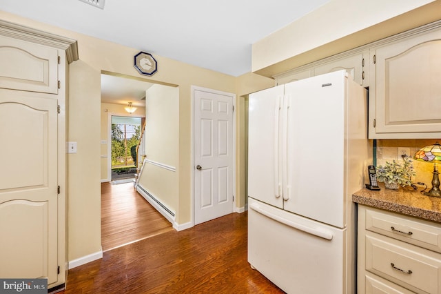 kitchen featuring white refrigerator, tasteful backsplash, a baseboard radiator, and dark hardwood / wood-style floors