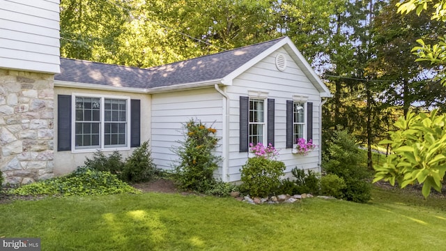 view of outbuilding with a lawn