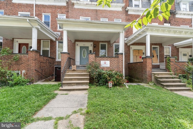 property entrance with a yard and a porch